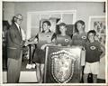 Frank Lepherd presents winning Botany Bay Stuart shield to Ken Beashel and crew of Big Bear 1960/61. Photo taken in our second of four clubhouses, now buried under the Captain Cook Bridge! © St George Sailing Club