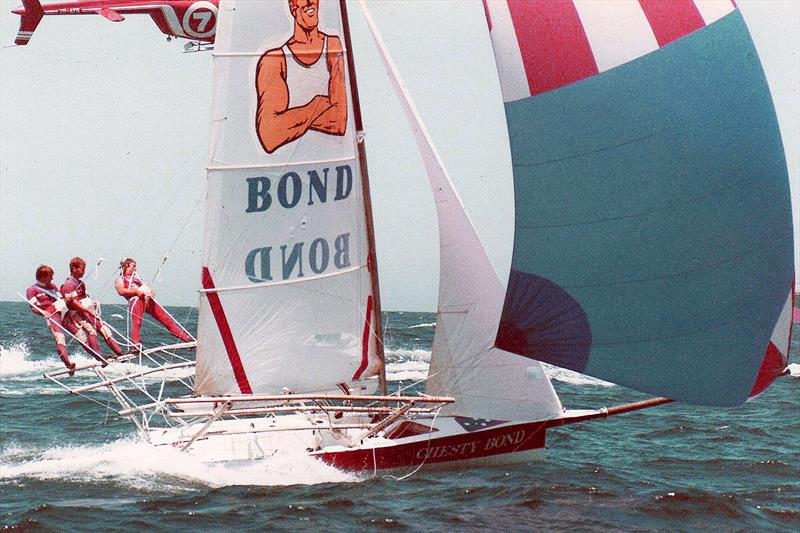 Chesty Bond, followed by a local TV helicopter, on the way to winning the Ocean Challenge in 1985 photo copyright Frank Quealey taken at Australian 18 Footers League and featuring the 18ft Skiff class