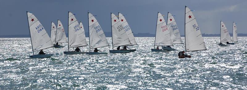 Starlings awaiting a heat start at the 2017 Nationals sailed at Wakatere Boating Club in 2017. Remarkably, the boat third from the right (#32) dates to the beginnings of the class in 1970, 47 years earlier photo copyright Brian Peet taken at  and featuring the Starling class