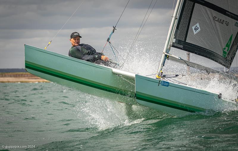 Unicorn and A Class Catamaran Nationals at Hayling Ferry SC: Grant Piggott gets air on the GRP Unicorn, built by his father many years ago, and beautifully restored photo copyright Gordon Upton / www.guppypix.com taken at Hayling Ferry Sailing Club and featuring the Unicorn class